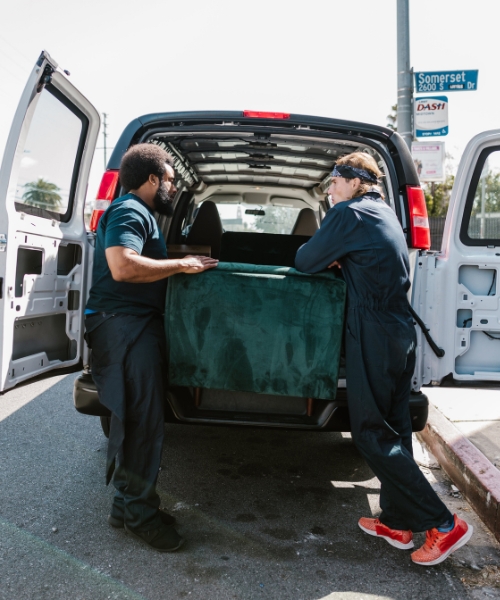 workers hauling away old furniture